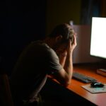 a man sitting at a desk in front of a computer